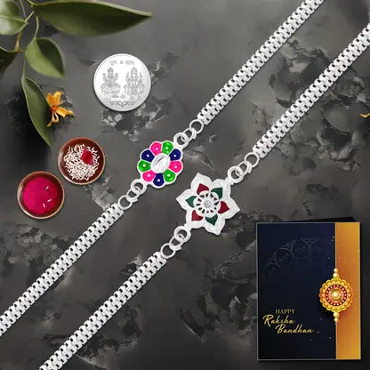 Rakhi Gift Combo With 2 Stylish Floral Rakhis For Brother  Includes Silver Coin Roli Chawal  Greeting Card Rakhi Gift Combo With 2 Stylish Floral Rakhis For Brother  Includes Silver Coin Roli Chawal  Greeting Card